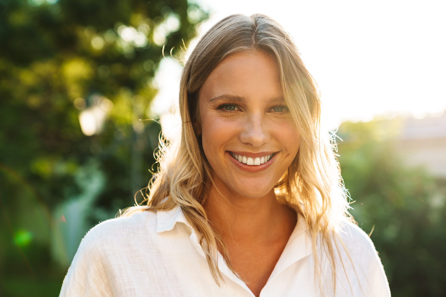 woman smiling back lit by sunlight